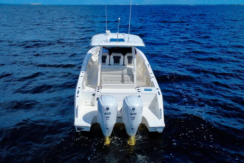 Slide: The Image of 2023 Pursuit S 358 Sport boat on open water, rear view with dual engines. - 3