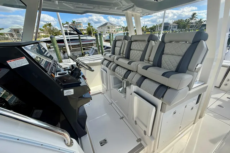 Slide: The Image of 2023 Pursuit S 358 Sport boat interior with luxurious seating and modern helm controls. - 32