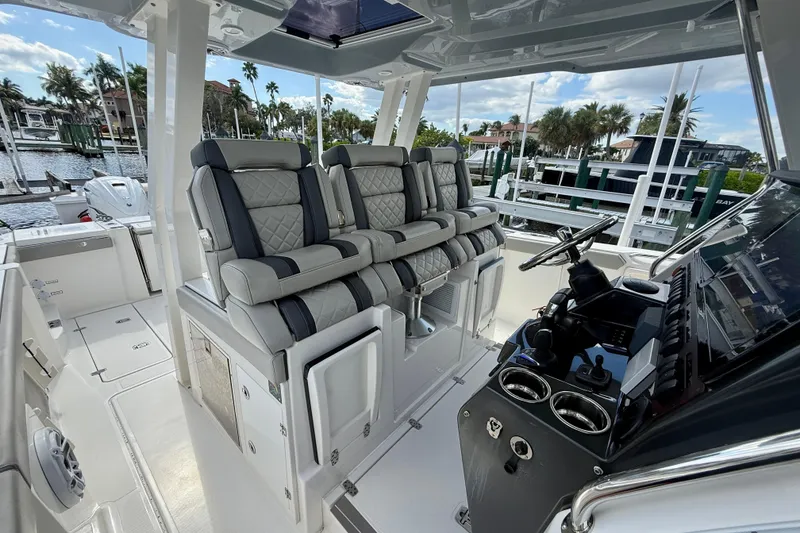 Slide: The Image of 2023 Pursuit S 358 Sport boat interior with luxurious seating and modern dashboard. - 33