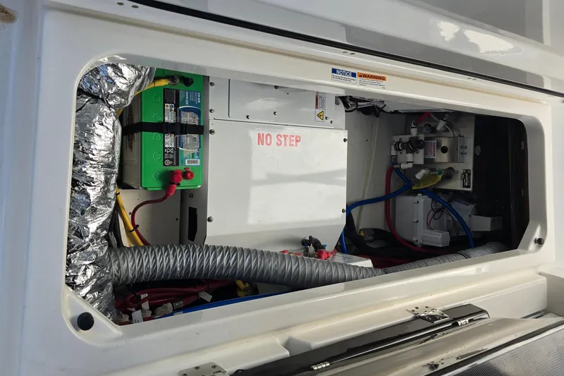 Slide: The Image of 2023 Pursuit S 358 Sport boat electrical compartment with wiring and battery setup. - 36