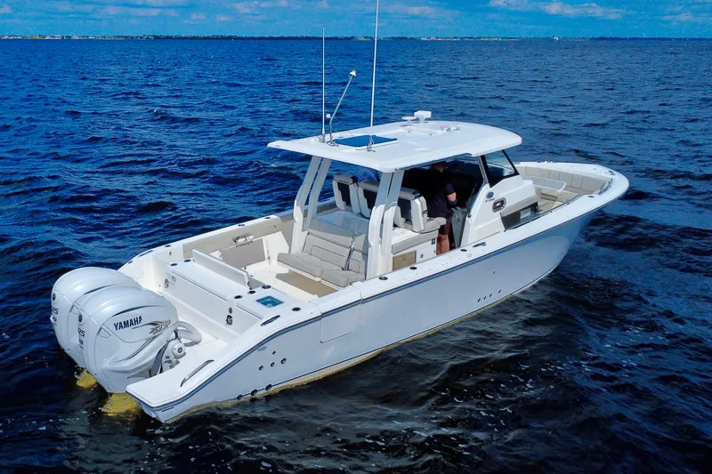 Slide: The Image of 2023 Pursuit S 358 Sport boat cruising on open water with twin Yamaha engines. - 5