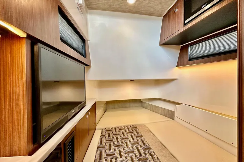 Slide: The Image of 2023 Pursuit S 358 Sport interior with modern wood finishes and built-in TV. - 61