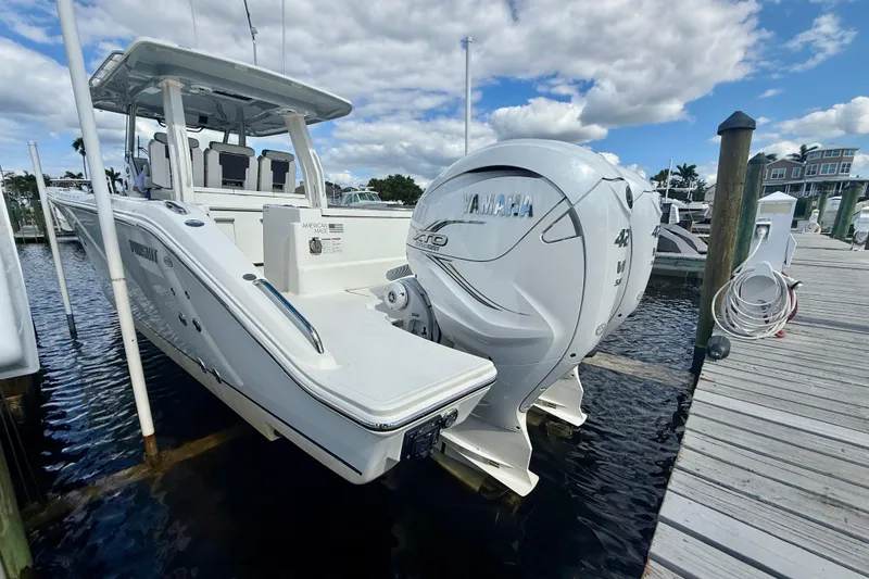 Slide: The Image of 2023 Pursuit S 358 Sport boat docked, featuring Yamaha outboard engines under a partly cloudy sky. - 8