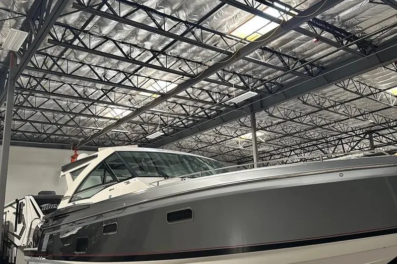 Slide: The Image of 2019 Formula 430 Super Sport Crossover boat in a warehouse setting. - 11