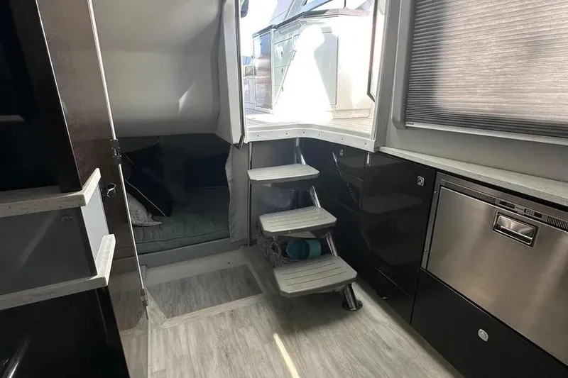 Slide: The Image of Interior of a 2019 Formula 430 Super Sport Crossover with modern kitchen and cozy seating area. - 8