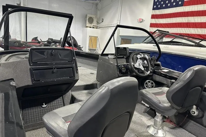 Slide: The Image of 2022 Tracker Targa V-19 Combo trailer wheels on a concrete surface. - 5