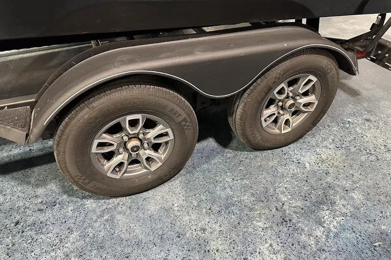 Slide: The Image of 2022 Tracker Targa V-19 Combo boat interior with steering wheel and dashboard controls. - 7