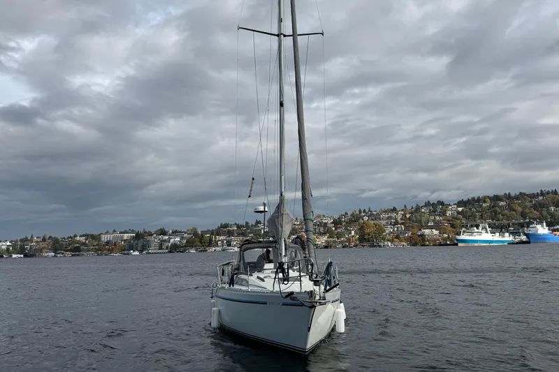 Slide: The Image of Sailboat Moody 346 (1987) on a lake with cloudy skies and distant shoreline. - 1