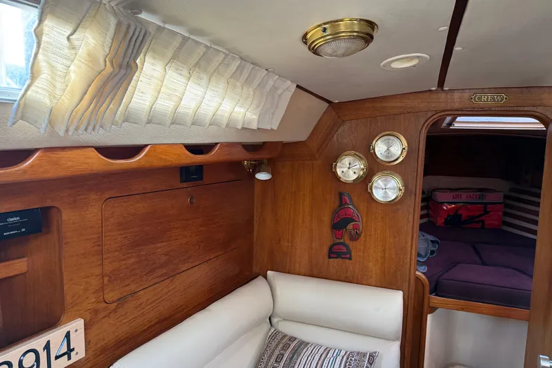 Slide: The Image of Cozy 1987 Moody 346 yacht interior with wood paneling and nautical decor. - 10