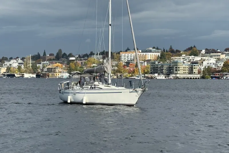Slide: The Image of Sailboat on water with cityscape background, Moody 346 model, 1987. - 2