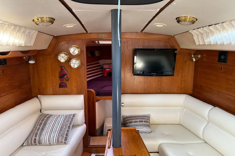 Slide: The Image of Luxurious interior of 1987 Moody 346 yacht with white seating and wooden accents. - 20