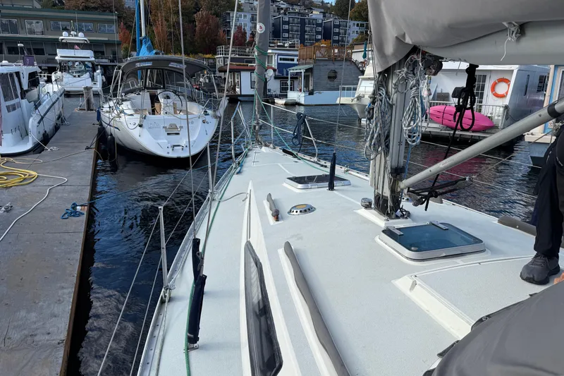 Slide: The Image of Sailboat Moody 346, 1987 model, docked at marina with other boats nearby. - 22