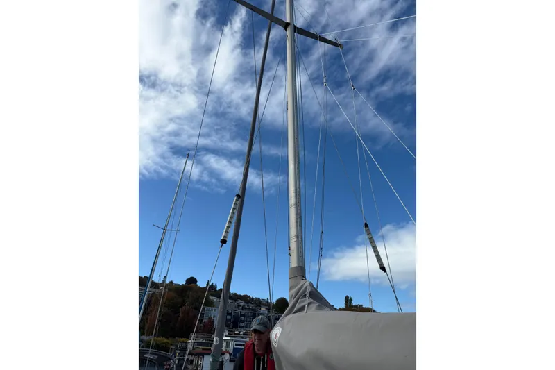 Slide: The Image of Sailboat mast of 1987 Moody 346 against a blue sky with clouds. - 24