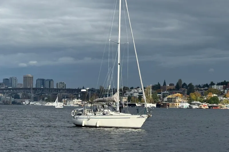 Slide: The Image of Sailboat Moody 346 (1987) on water with cityscape and bridge in background. - 29