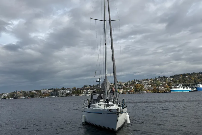 Slide: The Image of Sailboat Moody 346 (1987) on a cloudy day, with scenic waterfront background. - 3