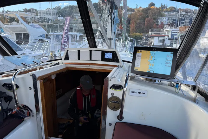 Slide: The Image of Cockpit view of 1987 Moody 346 sailboat with navigation equipment and marina background. - 7