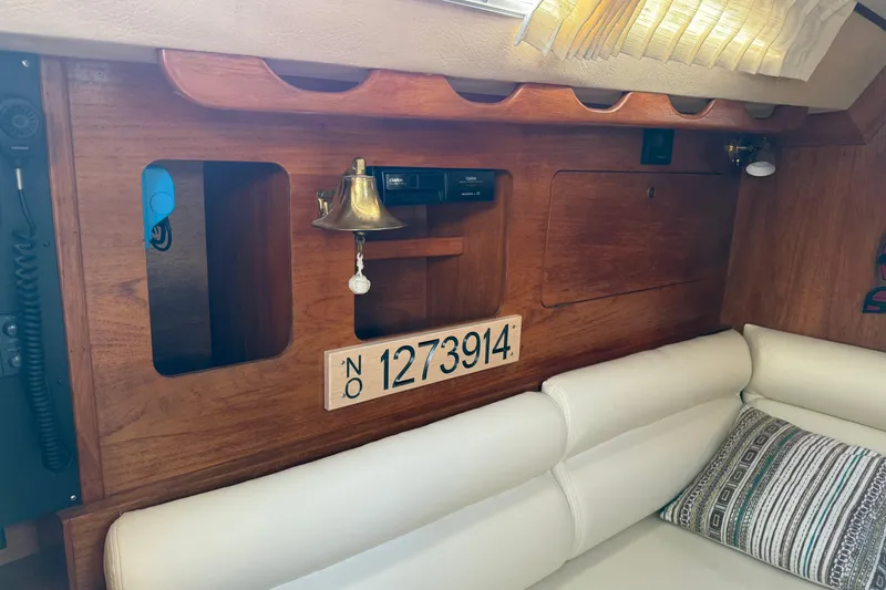 Slide: The Image of Interior of 1987 Moody 346 sailboat with wooden paneling and seating area. - 9