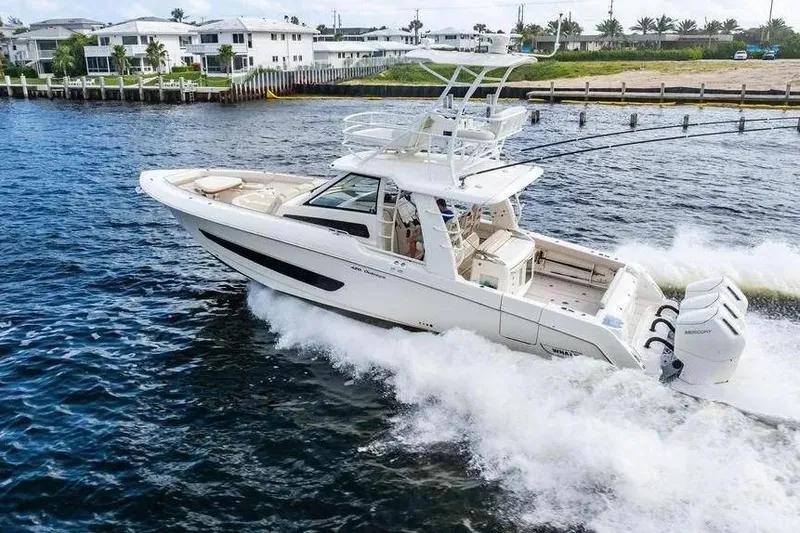 Slide: The Image of 2022 Boston Whaler 420 Outrage cruising on water, showcasing luxury and performance. - 12