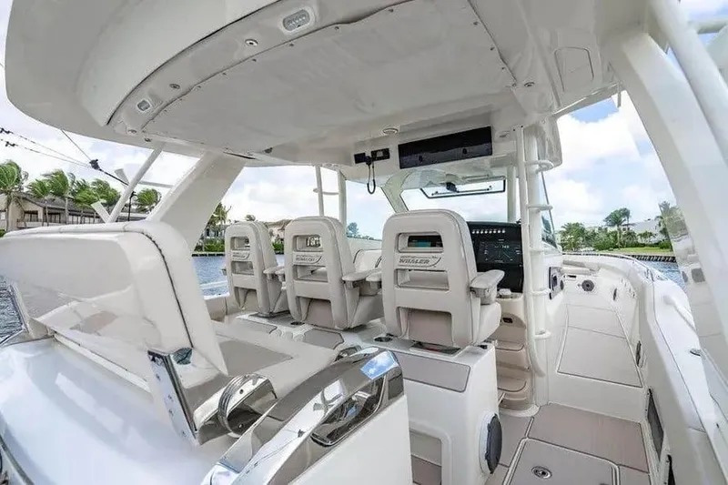 Slide: The Image of 2022 Boston Whaler 420 Outrage boat interior with helm seats and control panel. - 26