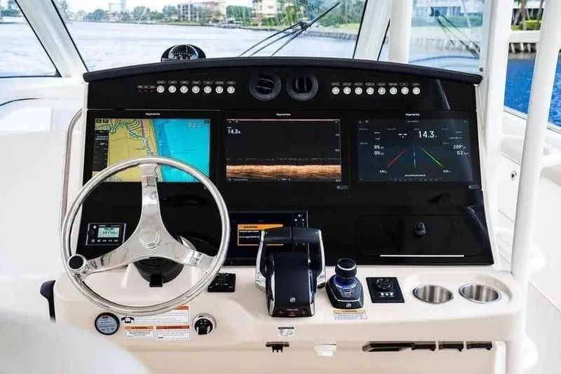 Slide: The Image of 2022 Boston Whaler 420 Outrage helm with advanced navigation displays and controls. - 28