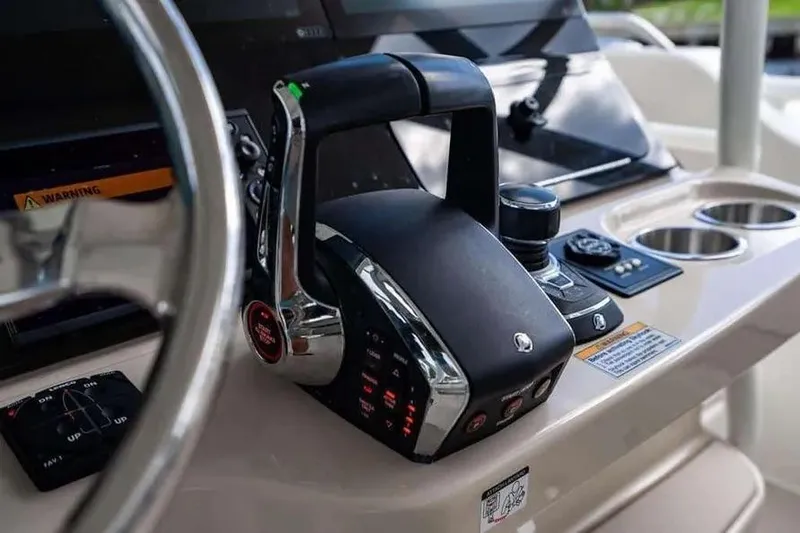 Slide: The Image of Control panel of 2022 Boston Whaler 420 Outrage boat with throttle and steering wheel. - 30