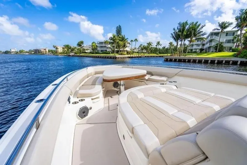 Slide: The Image of 2022 Boston Whaler 420 Outrage boat interior with luxurious seating and scenic waterfront view. - 35