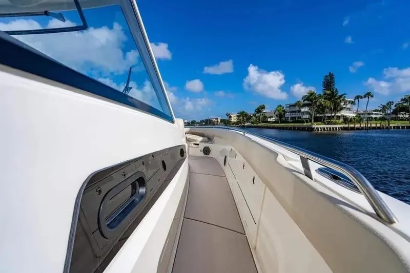 Slide: The Image of 2022 Boston Whaler 420 Outrage boat on water, clear sky, waterfront view. - 38