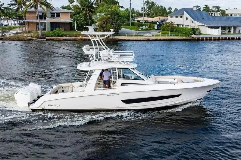 Slide: The Image of 2022 Boston Whaler 420 Outrage cruising on a scenic waterway. - 4