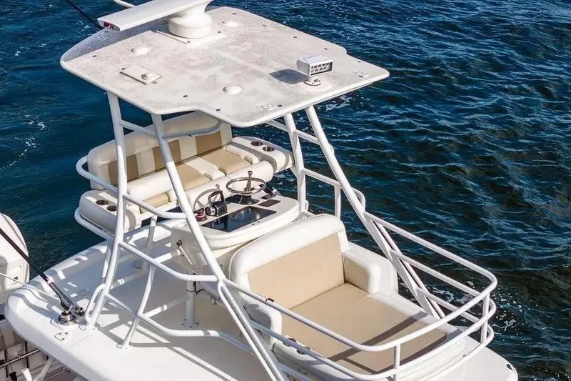 Slide: The Image of Boston Whaler 420 Outrage 2022 boat with upper deck seating and steering, on blue water. - 9