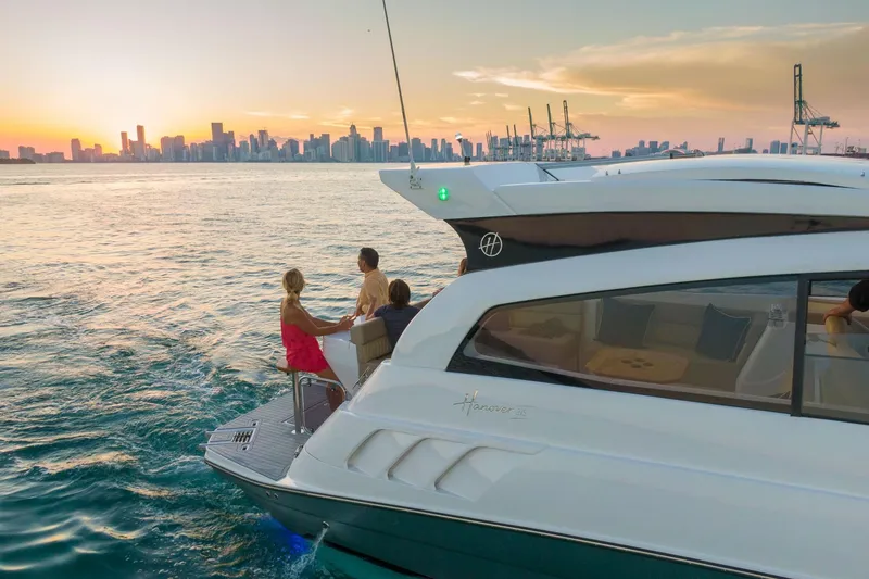 Slide: The Image of Luxury Hanover 375 yacht cruising at sunset near city skyline, 2026 model. - 10