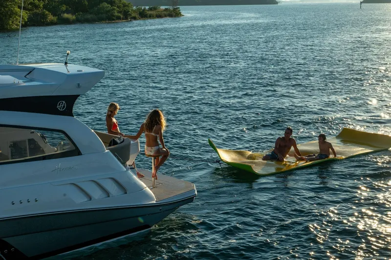 Slide: The Image of Luxury Hanover 375 yacht with people enjoying water activities, 2026 model. - 102