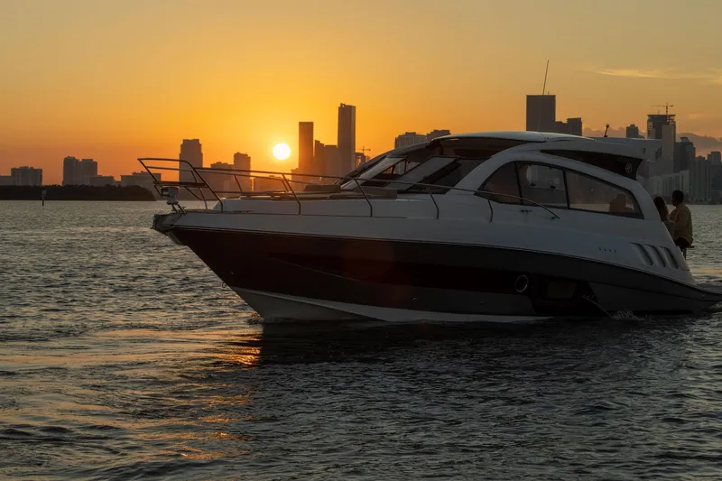 Slide: The Image of Luxury Hanover 375 yacht cruising at sunset near city skyline, 2026 model. - 113