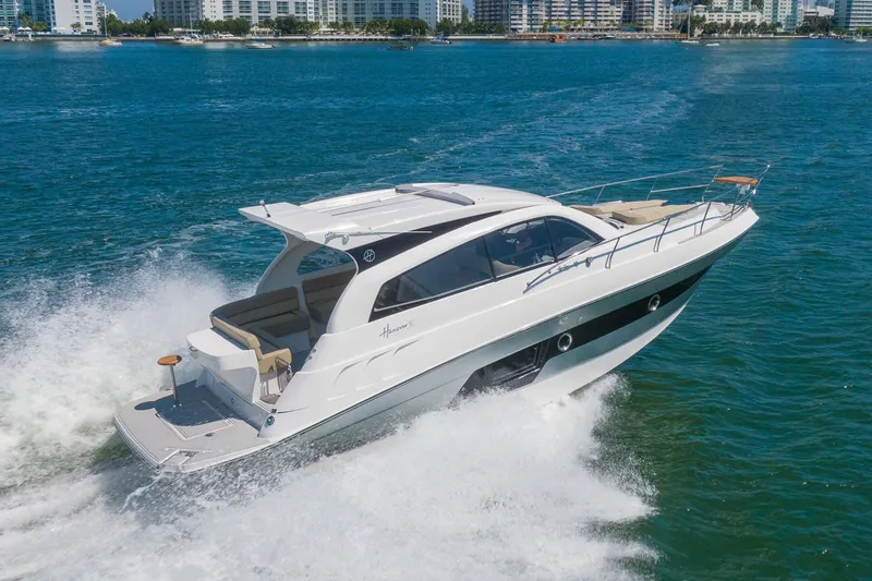 Slide: The Image of Luxurious 2026 Hanover 375 yacht cruising on blue waters near city skyline. - 24