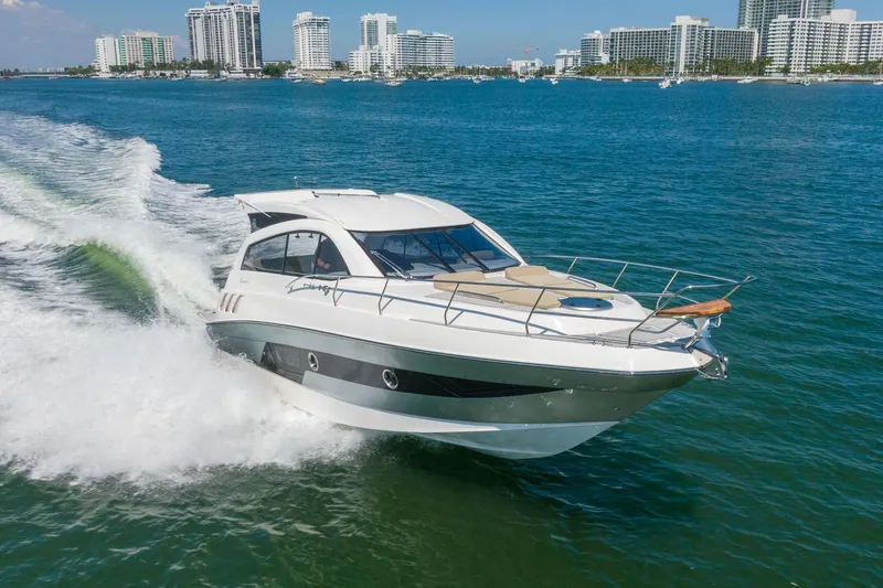 Slide: The Image of 2026 Hanover 375 yacht cruising on blue ocean near city skyline. - 25