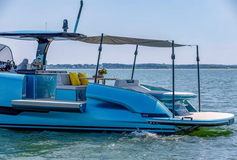 Slide: The Image of 2022 Solaris Power 44 yacht on calm water, featuring sleek design and sunshade canopy. - 11