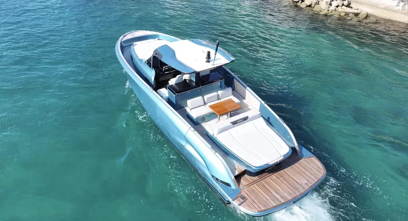 Slide: The Image of 2022 Solaris Power 44 yacht cruising on clear blue water, showcasing sleek design and spacious deck. - 2