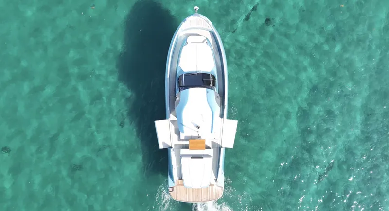 Slide: The Image of Overhead view of 2022 Solaris Power 44 yacht on clear turquoise water. - 3