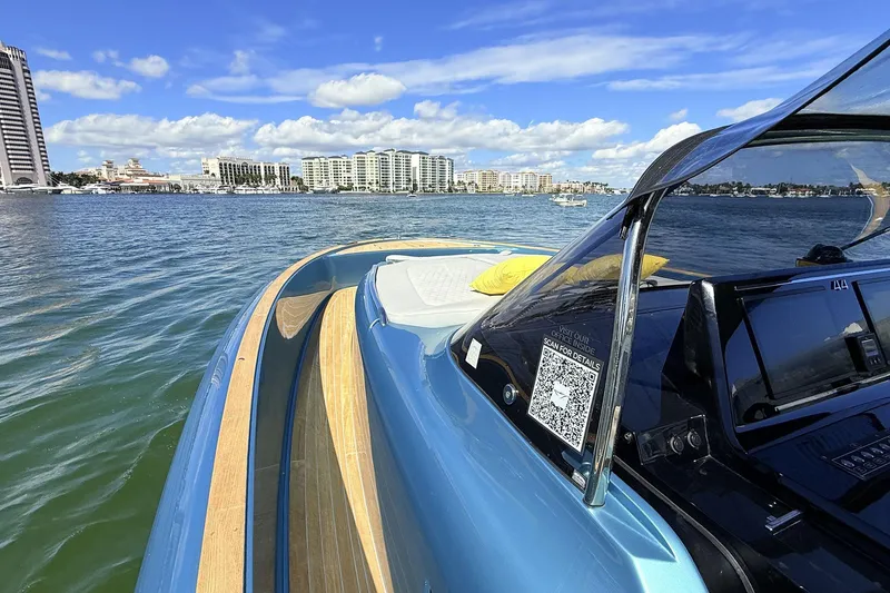 Slide: The Image of 2022 Solaris Power 44 yacht cruising on a sunny day with city skyline in background. - 32