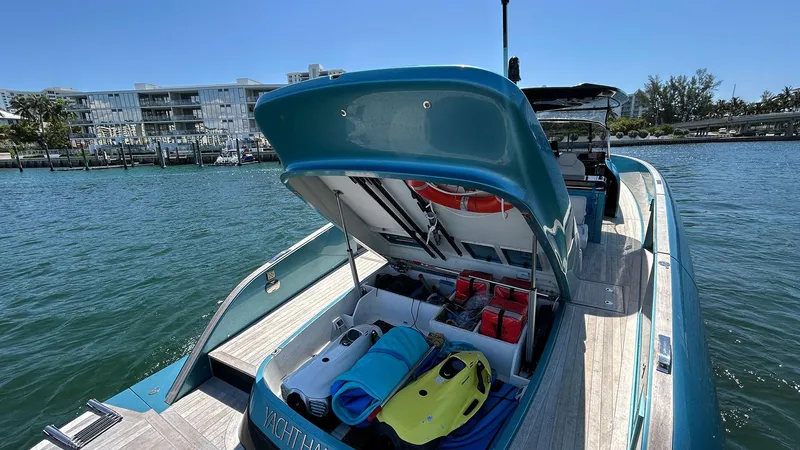 Slide: The Image of 2022 Solaris Power 44 yacht with open storage, docked by waterfront buildings. - 35