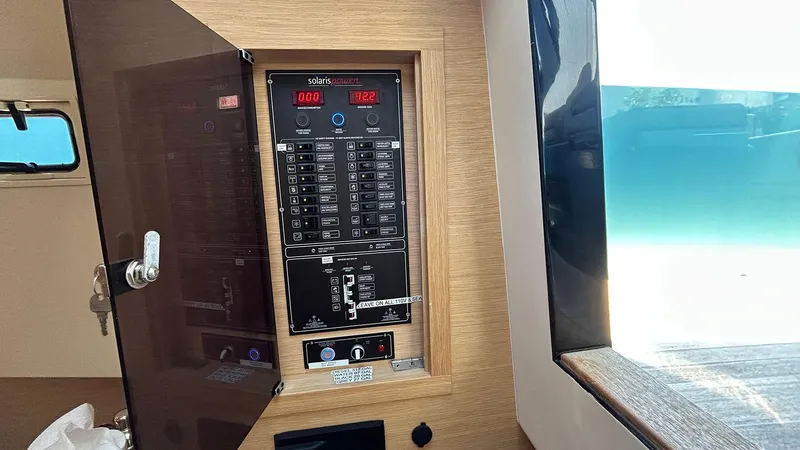 Slide: The Image of Electrical panel inside 2022 Solaris Power 44 yacht, featuring control switches and digital displays. - 46