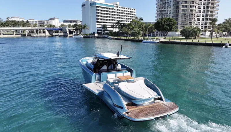 Slide: The Image of 2022 Solaris Power 44 yacht cruising in a scenic urban waterway. - 5