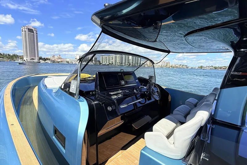 Slide: The Image of Luxurious 2022 Solaris Power 44 yacht interior with modern helm, overlooking scenic waterfront cityscape. - 6