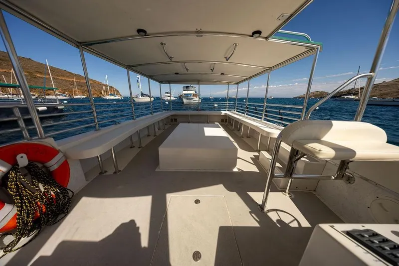 Slide: The Image of Open deck of a 2018 Seahawk Island Hopper boat, docked in a scenic marina. - 8