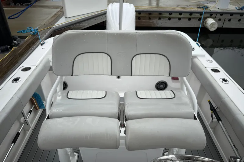 Slide: The Image of 2023 Sea Fox 248 Commander boat seating with sleek white upholstery at dock. - 11