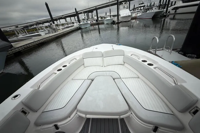 Slide: The Image of 2023 Sea Fox 248 Commander boat with spacious seating at a marina. - 14