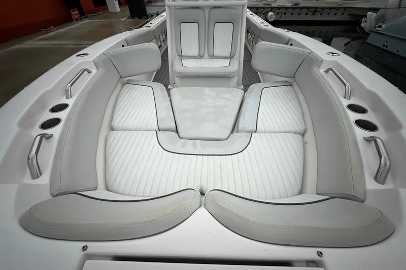 Slide: The Image of 2023 Sea Fox 248 Commander boat interior with white cushioned seating and cup holders. - 15