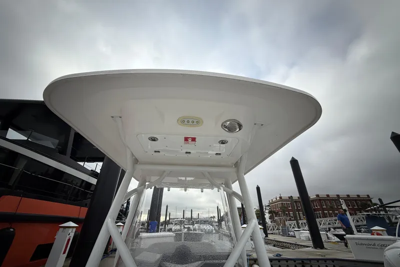 Slide: The Image of 2023 Sea Fox 248 Commander boat at dock, viewed from below, showcasing its canopy. - 21