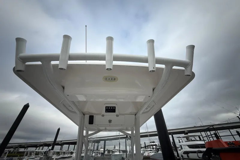 Slide: The Image of 2023 Sea Fox 248 Commander boat with rod holders and T-top under cloudy sky. - 22