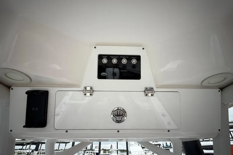 Slide: The Image of Control panel of 2023 Sea Fox 248 Commander boat with switches and storage compartment. - 23