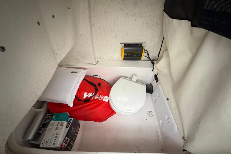 Slide: The Image of 2023 Sea Fox 248 Commander interior with marine toilet and storage items. - 24